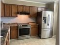 Kitchen featuring stainless steel appliances, and warm-toned wooden cabinets at 1807 Park North Bnd, Indianapolis, IN 46260