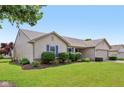 Lovely single-story home featuring blue shutters and lush landscaping, providing an inviting curb appeal at 2127 Yosemite Dr, Lebanon, IN 46052