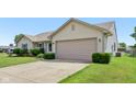 View of a single-story home's side profile, showcasing a well-maintained lawn and an attached two car garage at 2127 Yosemite Dr, Lebanon, IN 46052
