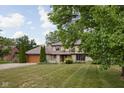 Charming two-story home featuring a well-manicured lawn, stone accents, and a two-car garage at 3818 S Creekside Dr, New Palestine, IN 46163