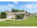 Beautiful one-story brick home featuring a well-maintained lawn and charming landscaping at 3920 Oak Harbor Ln, Indianapolis, IN 46237