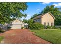 Charming exterior of a two-story home featuring a brick driveway, manicured lawn, and well-maintained landscaping at 4224 River Rd, Columbus, IN 47203