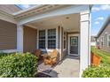 Inviting front porch with seating, offering a cozy spot to relax and enjoy the outdoors at 4905 Lilium Dr, Plainfield, IN 46168