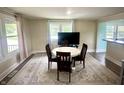 Bright dining room featuring a round table, four chairs, a neutral rug, and large windows for ample natural light at 514 E 2Nd St, Sheridan, IN 46069
