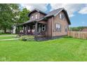 Inviting home with neat landscaping, a well-kept lawn, and charming architectural details at 514 E 2Nd St, Sheridan, IN 46069