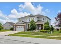 Attractive two-story home features a large front yard with manicured lawn and mature trees at 6137 Hardwick Dr, Whitestown, IN 46075