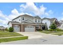 Beautiful exterior of a two-story home with a three-car garage and large driveway at 6137 Hardwick Dr, Whitestown, IN 46075