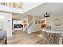 Open concept living room with hardwood floors, staircase and a view to the kitchen at 8380 Kolven Dr, Avon, IN 46123