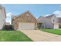 Single-story brick home with an attached garage and a neatly manicured lawn at 958 Denton Ct, Westfield, IN 46074