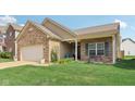 Well-kept single-story brick home with landscaped front yard and covered porch entrance at 958 Denton Ct, Westfield, IN 46074