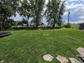 Expansive backyard featuring a trampoline, shed, and plenty of green space at 105 Cottonwood Dr, Maxwell, IN 46154