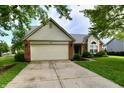 Attractive one-story home with brick and siding exterior, a two-car garage, and a neatly landscaped front yard at 10548 Magenta Dr, Noblesville, IN 46060