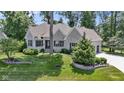 Charming stone home with a manicured lawn and landscaping at 10585 Golden Bear Way, Noblesville, IN 46060