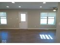 Bright living room featuring modern flooring, recessed lighting, and natural light from windows at 1155 E Perry St, Indianapolis, IN 46227