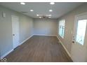 Spacious living room with ceiling fan, recessed lighting, and new flooring at 1155 E Perry St, Indianapolis, IN 46227