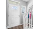 Bright entryway featuring a white door with half-round window and elegant staircase at 1158 Thistlewood Way, Plainfield, IN 46168