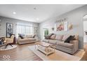 Comfortable living room with neutral tones, wood flooring, and a cozy seating arrangement at 1158 Thistlewood Way, Plainfield, IN 46168