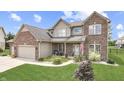Attractive two-story home with a well-maintained lawn, tidy landscaping, and a welcoming front porch at 1202 Vestman Ct, Greenwood, IN 46143