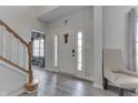 Bright foyer with hardwood flooring, staircase, and neutral paint at 1202 Vestman Ct, Greenwood, IN 46143