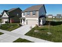 Beautiful two-story home with attached two-car garage and well-kept landscaping adding curb appeal at 1248 Cassine Pl, Greenwood, IN 46143