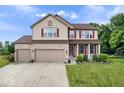 Charming two-story home featuring a three-car garage, brick accents, and well-maintained landscaping at 143 W Clear Lake Ct, Westfield, IN 46074