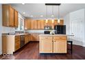 Well-lit kitchen features stainless steel appliances, hardwood floors, and a center island with seating at 143 W Clear Lake Ct, Westfield, IN 46074