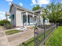 Quaint home with a welcoming porch and a well-tended yard at 146 E Broadway St, Shelbyville, IN 46176