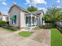 Well-kept home featuring a quaint porch and manicured yard at 146 E Broadway St, Shelbyville, IN 46176