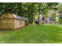 Spacious backyard with lush lawn, mature trees, and large shed at 18 Point Ln, Arcadia, IN 46030