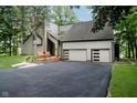 Exterior shot of home with a two-car garage and lush landscaping at 18 Point Ln, Arcadia, IN 46030