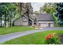 Contemporary home with an attached two-car garage and well-manicured lawn at 18 Point Ln, Arcadia, IN 46030