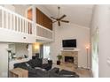 Spacious living room with vaulted ceilings, stone fireplace, and a cozy sectional sofa at 2578 Chaseway Ct, Indianapolis, IN 46268