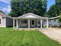 Charming home with a covered front porch, a swing, well-manicured lawn, and appealing curb appeal at 2822 Tindall St, Indianapolis, IN 46203
