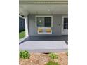 Cozy front porch with a charming white swing and yellow pillows, offering a relaxing outdoor space at 2822 Tindall St, Indianapolis, IN 46203