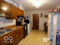 Functional kitchen featuring wooden cabinets, essential appliances, and ample storage space at 3213 S Cherokee Rd, Muncie, IN 47302