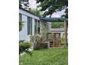 Side view of the home showcasing a porch and landscaping at 3216 Memorial N Dr, Elwood, IN 46036