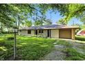 Well-kept ranch style home with attached garage, mature trees, and an expansive front lawn at 4765 E 200 N, Anderson, IN 46012