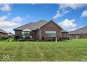 Spacious backyard boasts a well-maintained lawn and a charming deck with comfortable seating, perfect for outdoor relaxation at 4909 N Graystone Dr, Muncie, IN 47304