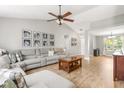 Spacious living room with vaulted ceiling, wood floors, and a large sectional sofa at 6102 Boulder Dr, Anderson, IN 46013