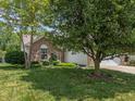 Charming home with brick facade, mature trees, and a well-maintained lawn at 6928 Shoals Way, Indianapolis, IN 46237