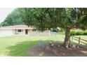Landscaped front yard featuring lawn, decorative gnomes, and view of home's exterior with American flag at 7326 Lowe Dr, Lawrence, IN 46226