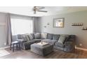 Comfortable living room with a large sectional sofa, neutral color palette, and wood-look flooring at 7326 Lowe Dr, Lawrence, IN 46226
