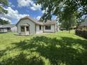 View of the backyard with grass and garden areas at 7450 Cobblestone W Dr, Indianapolis, IN 46236