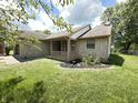 Stylish exterior featuring stone accents and a cozy covered porch at 7450 Cobblestone W Dr, Indianapolis, IN 46236