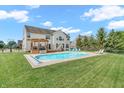 Inviting backyard featuring a sparkling in-ground pool and a spacious deck with pergola at 7830 Cross Creek, Avon, IN 46123