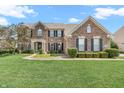 Beautiful brick home featuring a well-maintained lawn and tasteful landscaping at 7830 Cross Creek, Avon, IN 46123