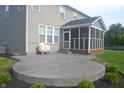 A concrete patio outside with a screened-in porch, perfect for relaxation and outdoor activities at 10166 Ranford Blvd, Fishers, IN 46040