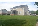 Spacious backyard featuring a well-maintained lawn and a screened-in porch at 10166 Ranford Blvd, Fishers, IN 46040