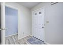 Bright entryway featuring a white front door, gray walls, and modern flooring at 10246 Liverpool Way, Indianapolis, IN 46236