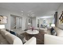 Spacious living room with modern furniture, neutral tones, and an open dining area at 10246 Liverpool Way, Indianapolis, IN 46236